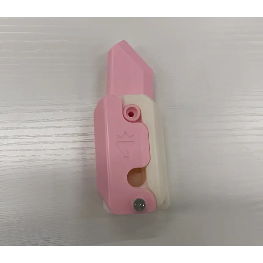 Pink and white plastic utility knife with retractable blade featured in lime radish knife gravity cub toy product lineup