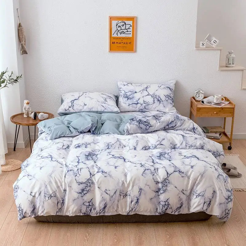 Pink and white marble bed sheets set featuring white and blue marble-patterned duvet cover with soft textured fabric finish