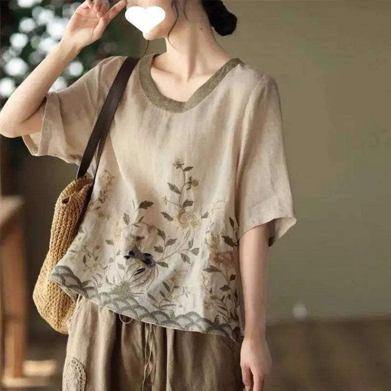A soft pink art retro embroidery linen top with beige linen round neckline and delicate floral detailing