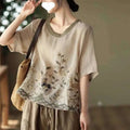 Beige linen round neck top with delicate pink art retro embroidery and contrasting olive green neckline