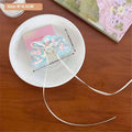 Pastel blue and pink heart-shaped resin charm with white ribbon on pink butterfly floral small secure jaw clip with bow