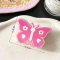 Pink butterfly floral small jaw clip with white heart details designed as a secure jaw clip with bow accents