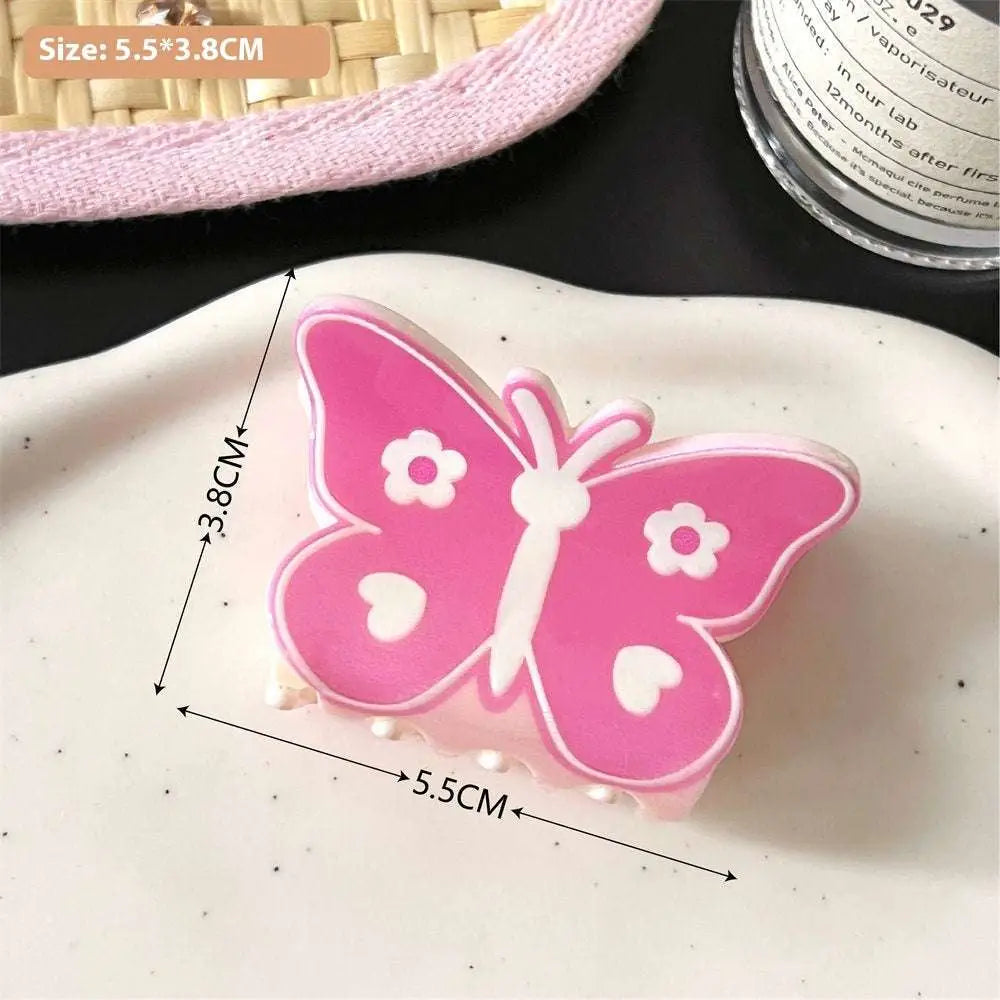 Pink butterfly floral small jaw clip with white heart details designed as a secure jaw clip with bow accents