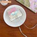 Pink butterfly floral small jaw clip with secure jaw clip features a white resin butterfly and light blue satin bow