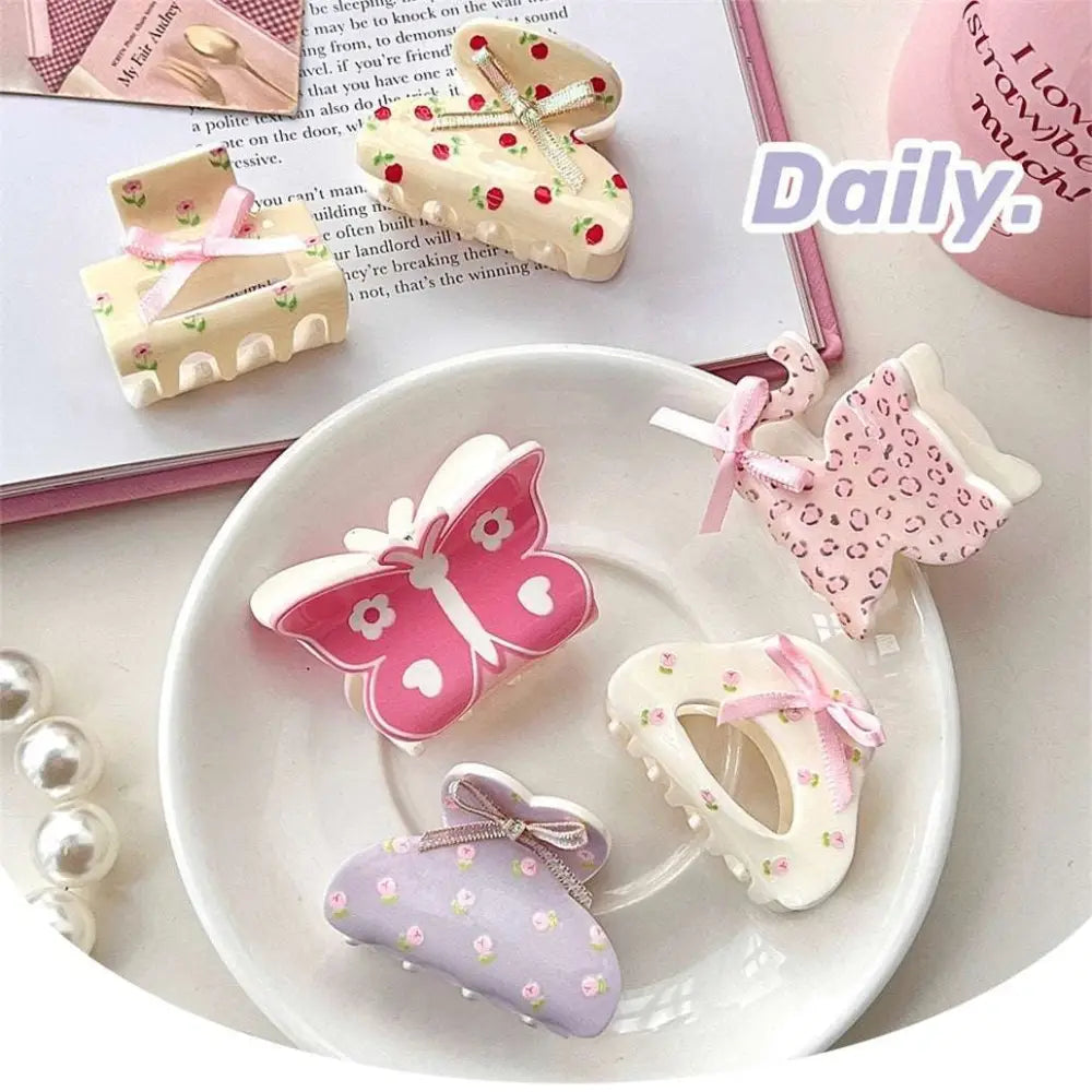Pastel pink butterfly floral small jaw clip with bow features secure jaw clip and delicate polka dot patterns