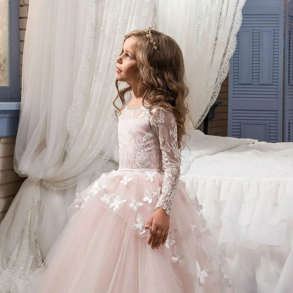 A delicate pink butterfly lace girls pengpeng skirt with long lace sleeves and white butterfly appliqués on tulle