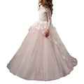 A blush pink butterfly lace girls pengpeng ball gown with long lace sleeves and tulle skirt adorned with butterfly appliqués