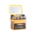 Yellow plastic cosmetic storage box with illuminated mirror lid and transparent compartments for celebrity desktop organization