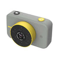 Pink digital mini camera for children in gray and yellow with circular lens assembly featuring multiple lenses