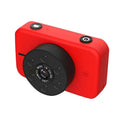Pink digital mini camera for children with red compact body and black circular lens assembly and two control buttons on top