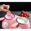 Pink dual chamber chocolate melting pot with two ceramic warming pots holding pink and white melted chocolate