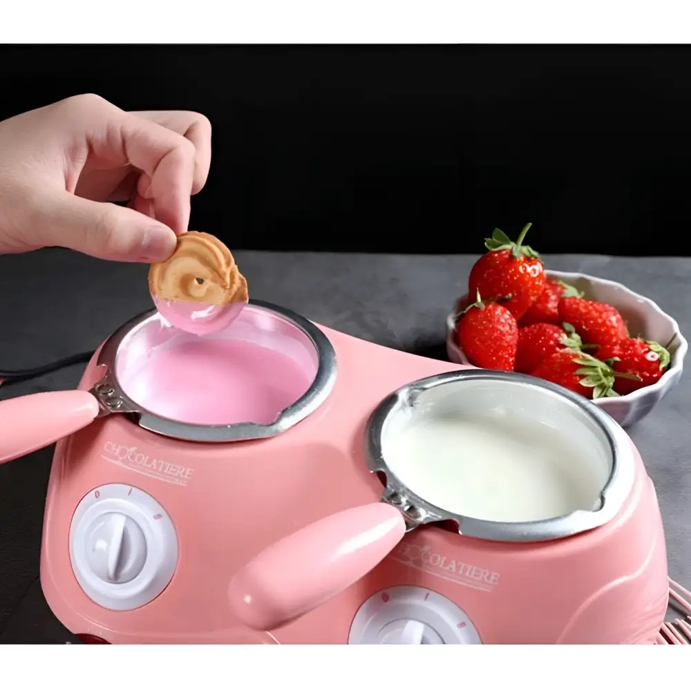Pink dual chamber chocolate melting pot with two ceramic warming pots holding pink and white melted chocolate