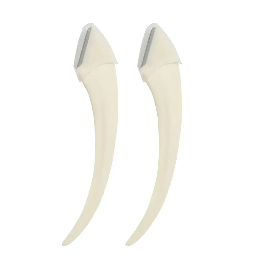 Cream-colored curved razor blades with sleek metallic edge in pink eyebrow trimming knife and scissors set for precise eyebrow trimmer