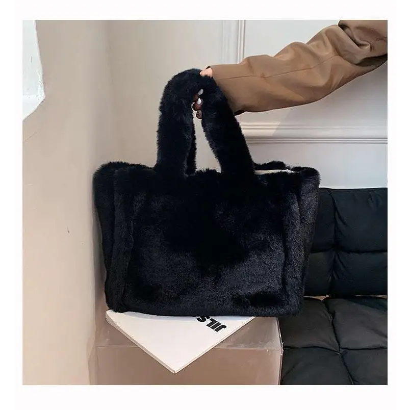 Black faux fur tote bag with soft plush texture and sturdy handles featured in pink faux fur chain plush handbag collection