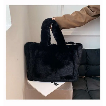 Black faux fur tote bag with soft plush texture and sturdy handles featured in pink faux fur chain plush handbag collection
