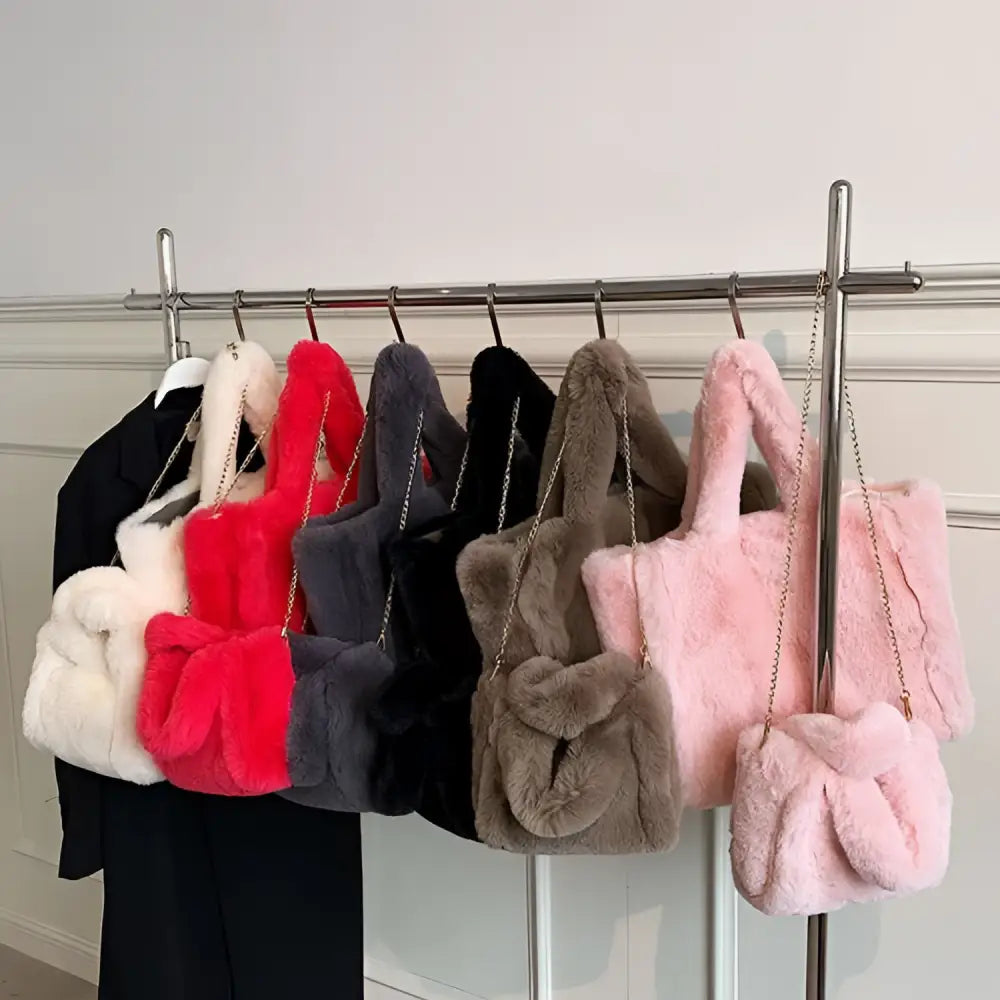 A collection of chain plush handbags in various colors featuring pink faux fur and soft plush texture with knotted design