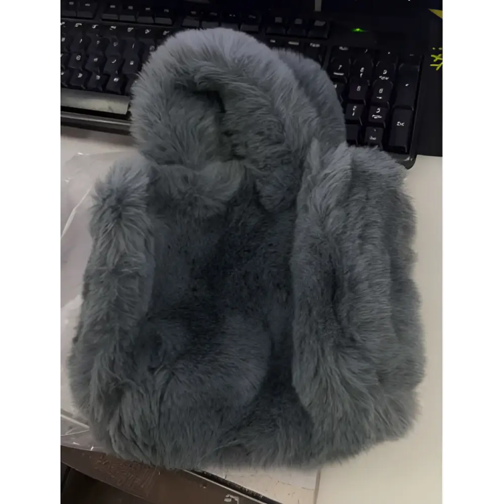 Gray faux fur phone case with soft plush texture and rounded edges complementing pink faux fur chain plush handbag