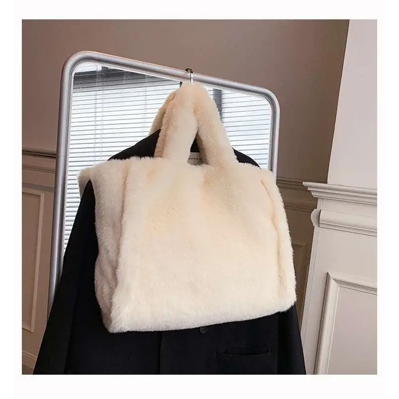 Cream-colored tote bag with soft plush texture and matching handles featured in pink faux fur chain plush handbag
