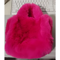 A vibrant pink faux fur chain plush handbag with soft plush texture and rounded handles for stylish use