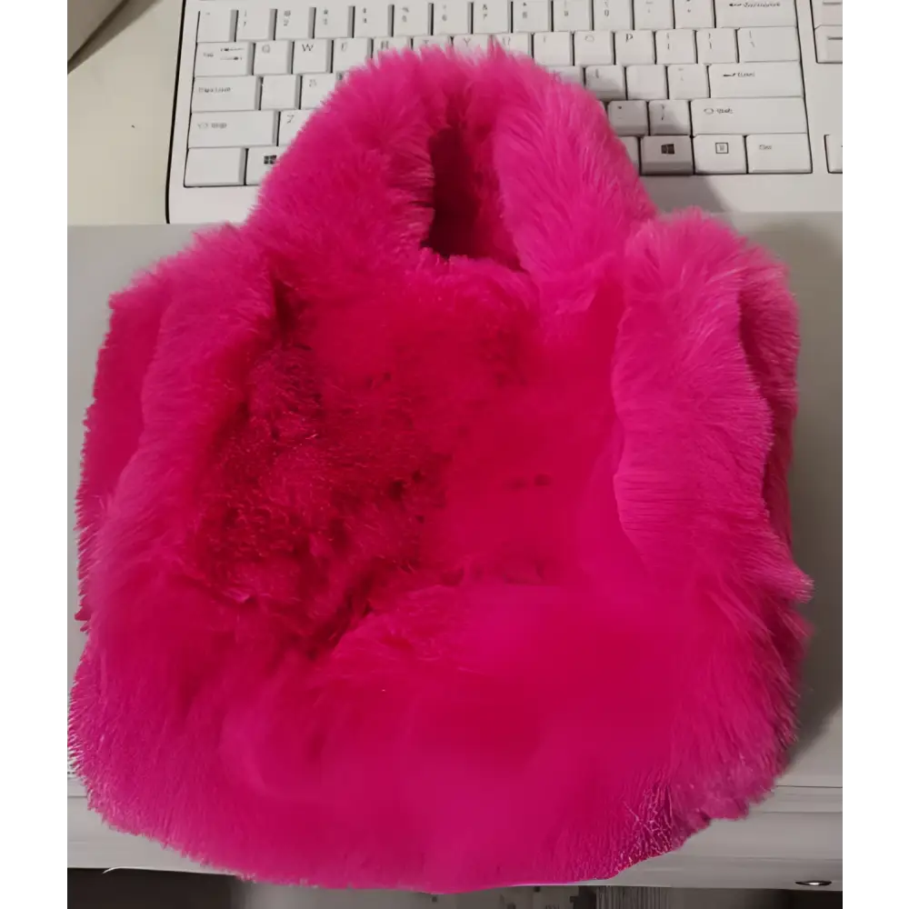 A vibrant pink faux fur chain plush handbag with soft plush texture and rounded handles for stylish use