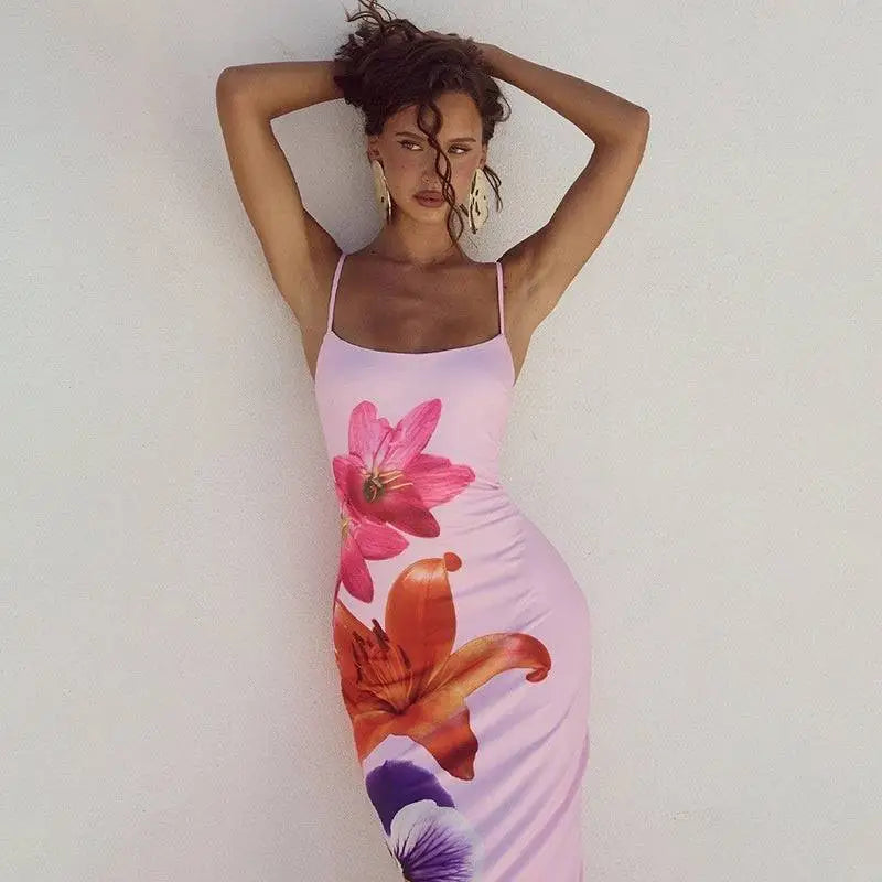 A form-fitting pink floral american style flower strap dress with vibrant magenta orange and purple prints