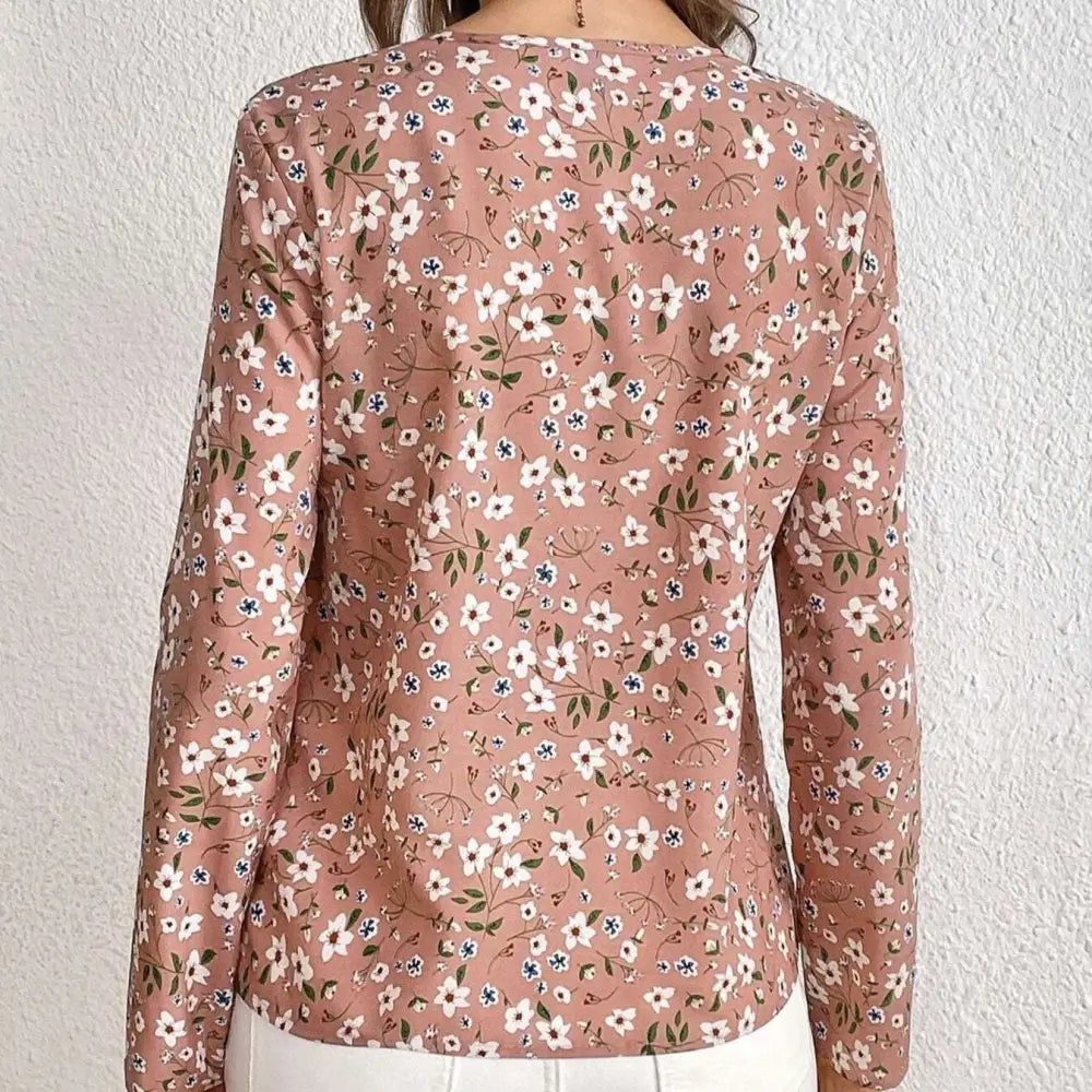 A soft pink floral casual blouse with long sleeves and a subtle print folding pleated front design