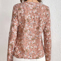 A pink floral casual long sleeved print folding pleated blouse with white and blue blossoms and green stems