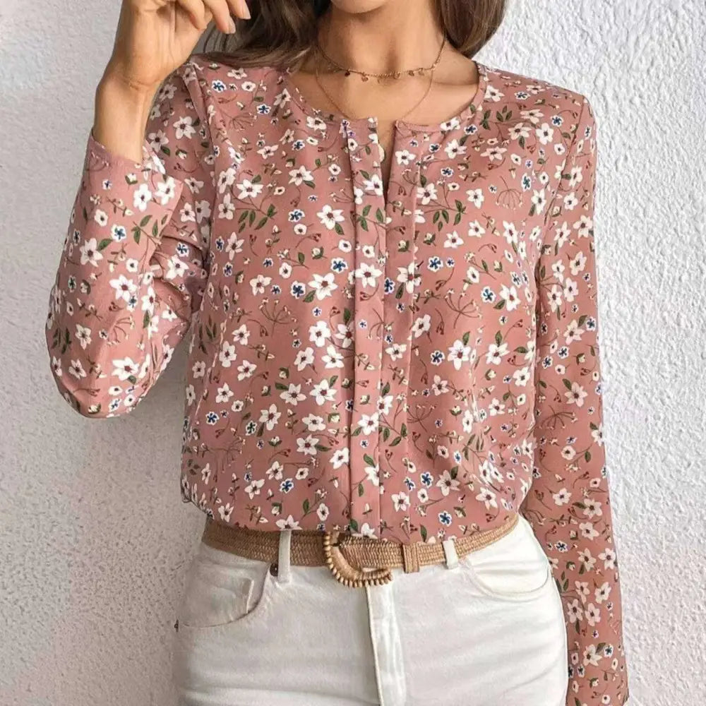 A soft pink floral casual blouse with long sleeves and a subtle print folding pleated front design
