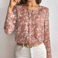 A soft pink floral casual blouse with long sleeves and a subtle print folding pleated front detail