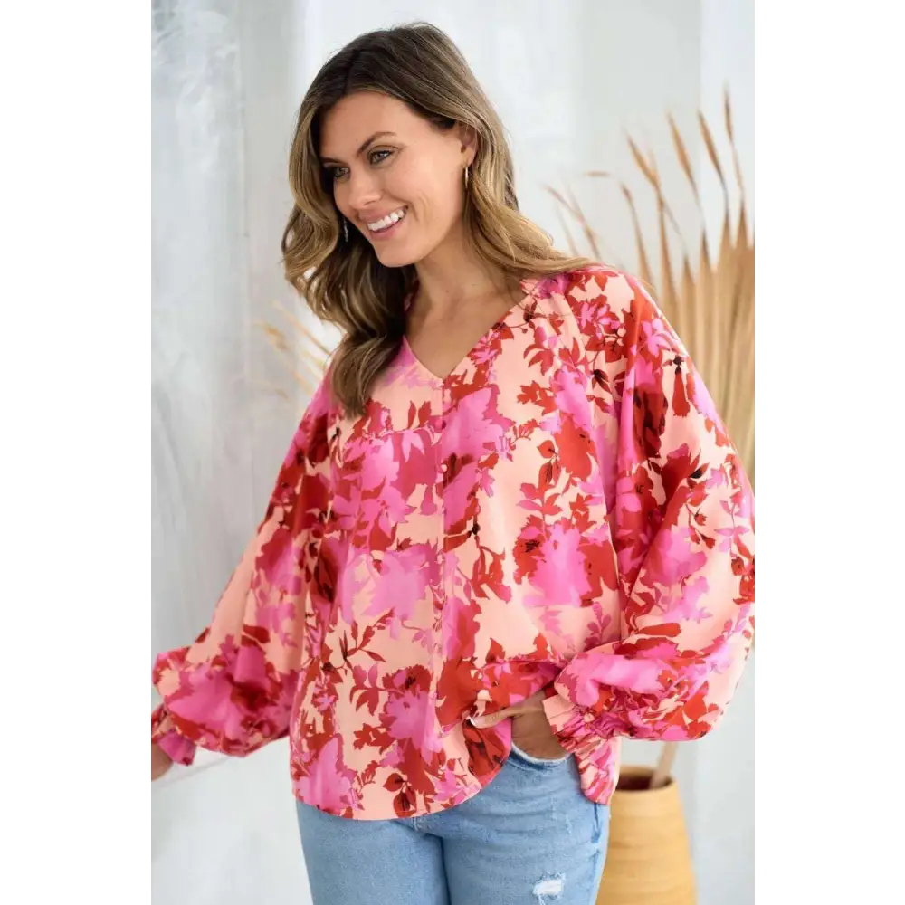 A vibrant pink and red button floral blouse with puffy sleeves ideal for stylish casual wear