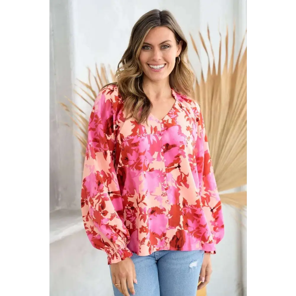 A vibrant pink and red button floral blouse with puffy sleeves ideal for stylish casual wear