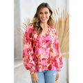 A vibrant pink and coral button floral blouse with long puffy sleeves perfect for stylish casual wear