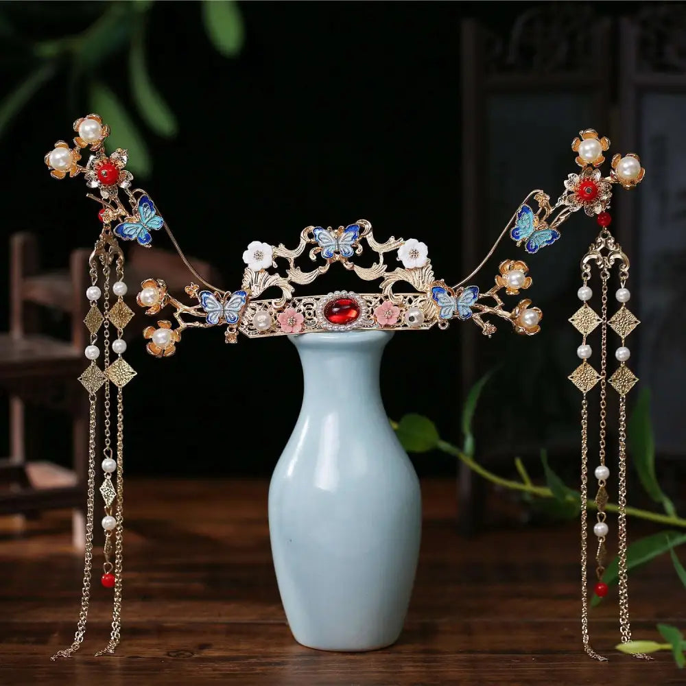 Pink floral hanfu hairpin crown adorned with gold, blue butterflies, pink blossoms, red gemstones, and pearl strands
