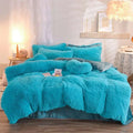 Pink fluffy faux fur plush duvet cover set with turquoise fluffy faux fur pillows and satin-lined base for bedroom use