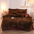 Pink fluffy faux fur plush duvet cover set with a brown faux fur comforter and matching shaggy pillows