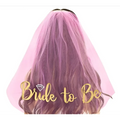 A delicate pink tulle bridal veil with gold foil bride lettering and diamond-shaped embellishment popular tulle design
