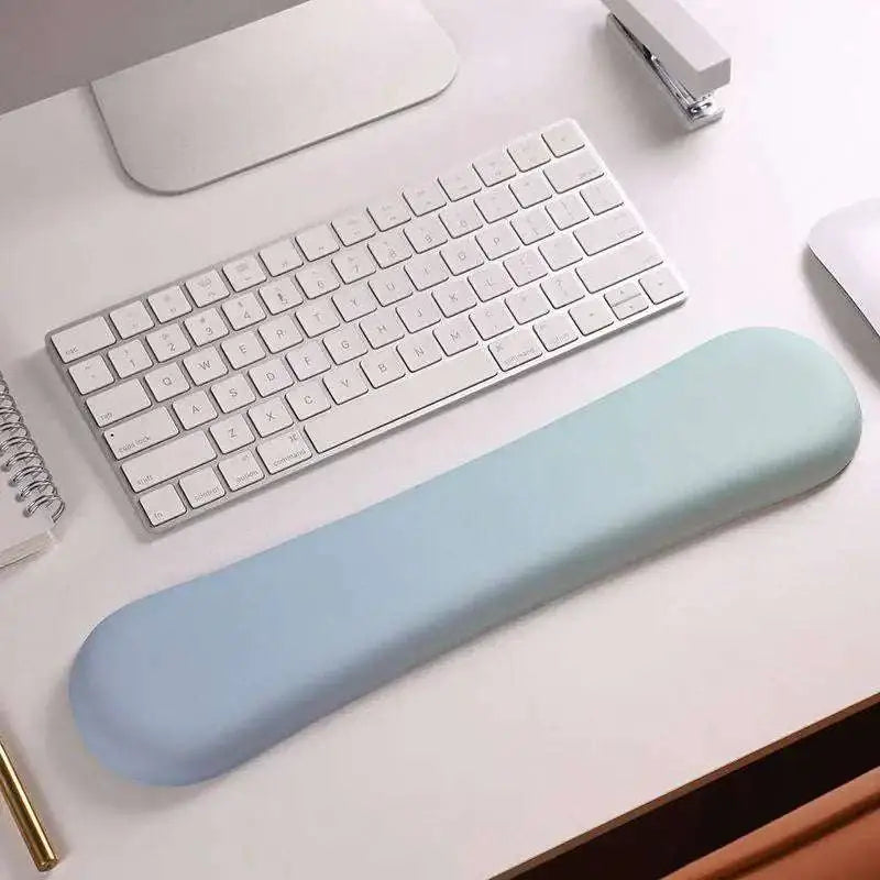 A soft light blue ergonomic wrist rest made of memory foam soft material for wrist health and comfort