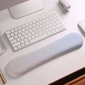Light blue ergonomic wrist rest with soft-touch surface designed for wrist health and memory foam soft support
