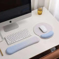 Light blue ergonomic wrist rest with memory foam soft surface and rounded edges for wrist health support