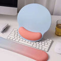 Pastel blue and peach ergonomic wrist rest made of memory foam soft material for wrist health in a pink gradient memory mouse pad