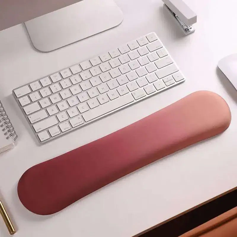 A pink gradient memory foam soft mouse pad with ergonomic wrist rest for enhanced wrist health and smooth soft-touch surface