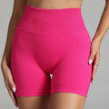 Pink high waist seamless yoga shorts with a ribbed waistband made from stretchy fabric for women