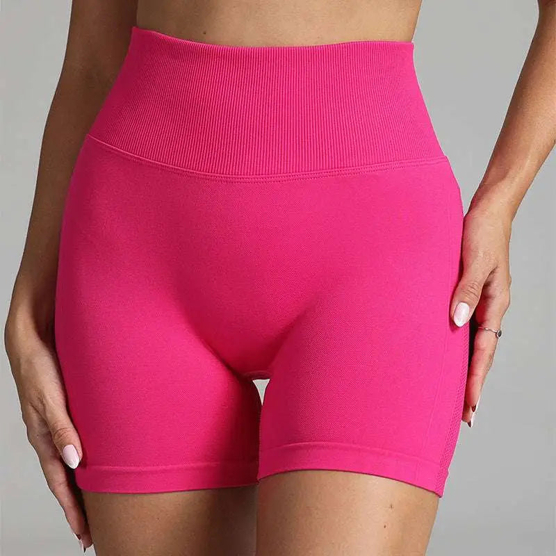 Pink high waist seamless yoga shorts with a ribbed waistband made from stretchy fabric for women