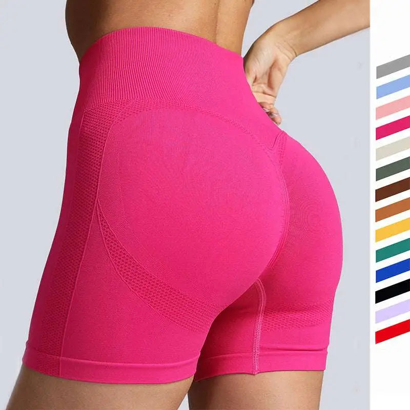 Pink high waist seamless yoga shorts with ribbed waistband, textured design, and breathable mesh panels for women