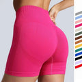Pink high waist seamless yoga shorts with ribbed waistband, textured design, and breathable mesh panels for women