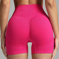 Pink high waist seamless yoga shorts for women featuring a ribbed waistband and breathable mesh panels