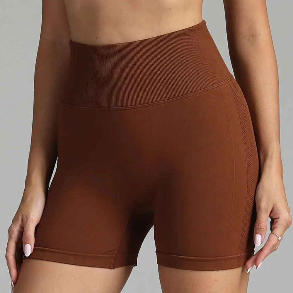 Brown high waist seamless yoga shorts with ribbed waistband and mesh side panels for women