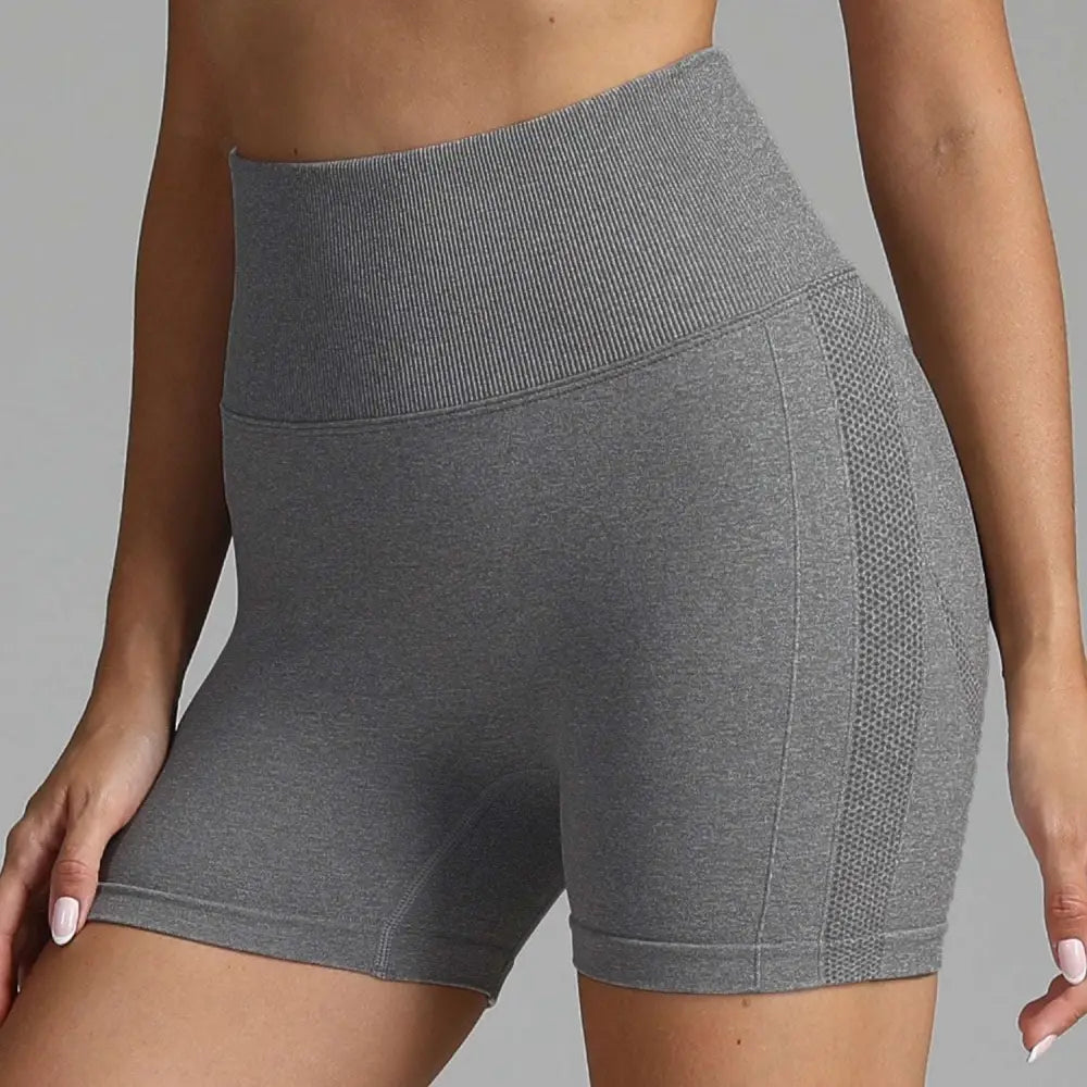 Gray high waist seamless yoga shorts with ribbed waistband and mesh panel on the side for women
