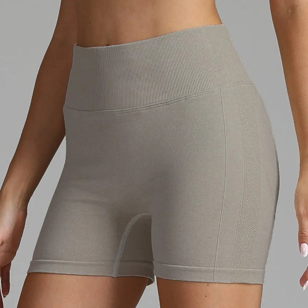 Gray high waist seamless yoga shorts with ribbed waistband and mesh panel detailing for women