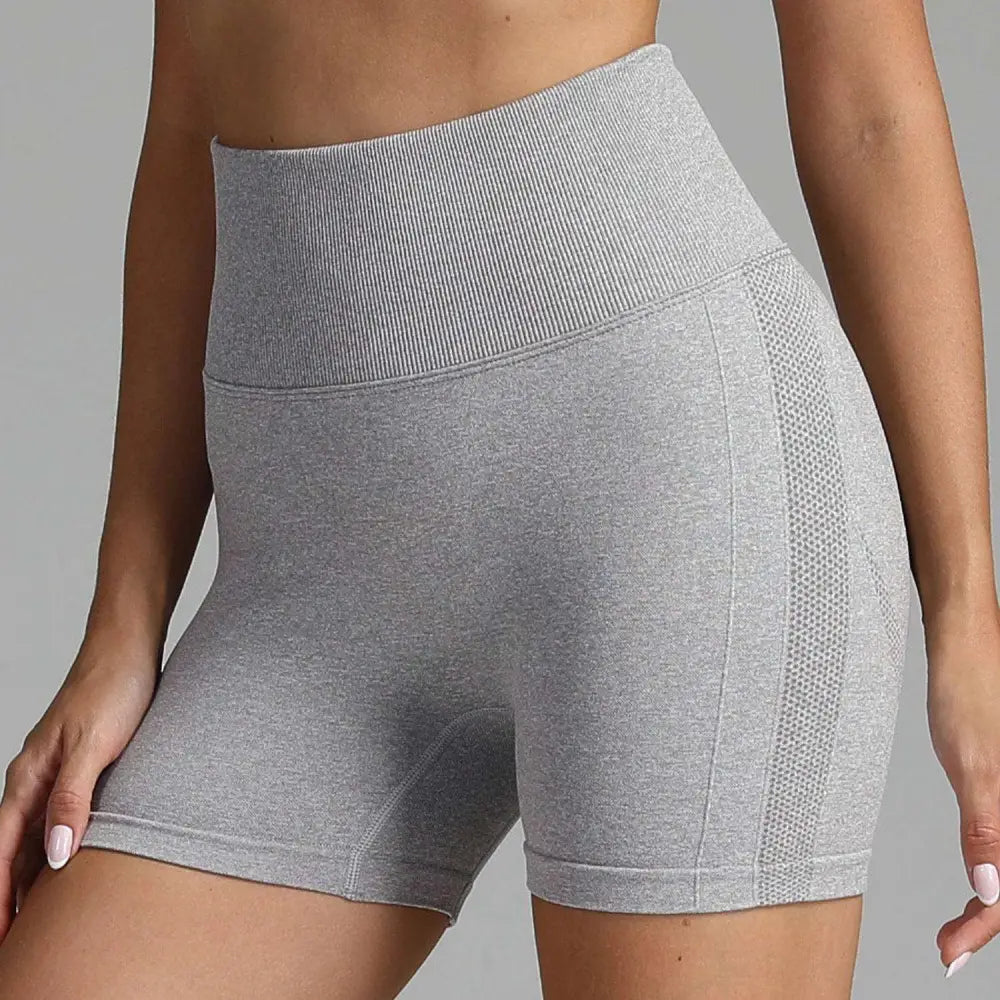 Gray high waist seamless yoga shorts with ribbed waistband and mesh side panels for women’s athletic wear